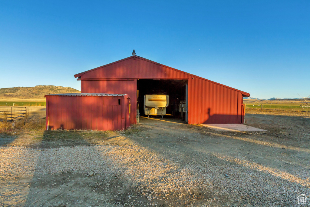 View of outbuilding featuring a mountain view and a rural view