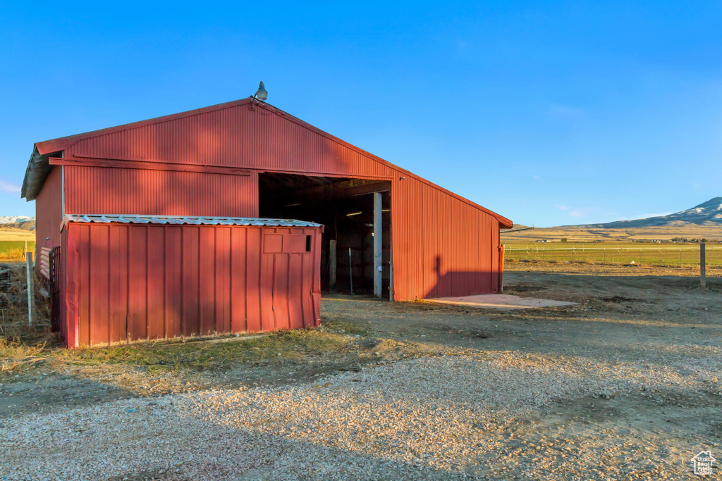 View of outdoor structure featuring a mountain view and a rural view