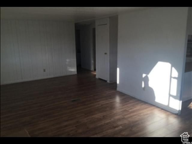 Unfurnished room with dark hardwood / wood-style flooring