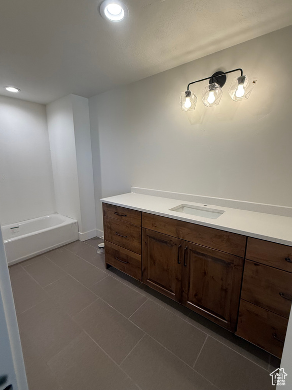 Bathroom featuring recessed lighting, a tub, tile patterned flooring, and vanity