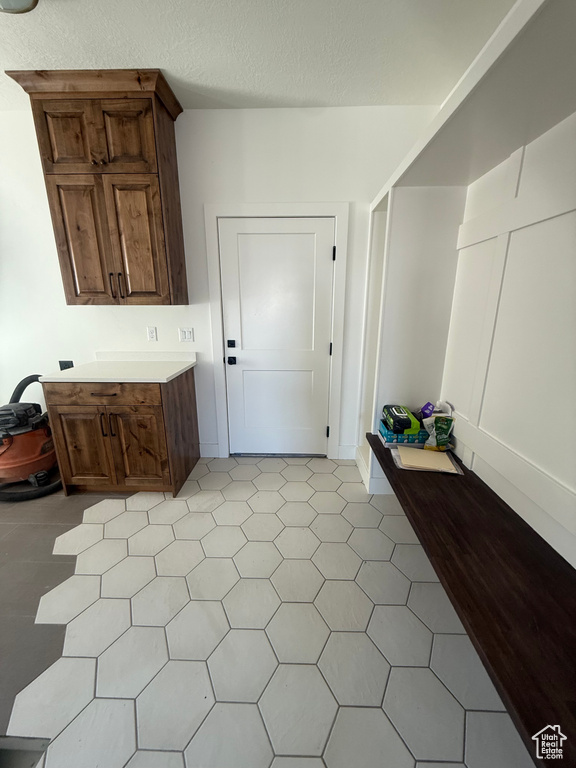 Interior space featuring a textured ceiling and light countertops