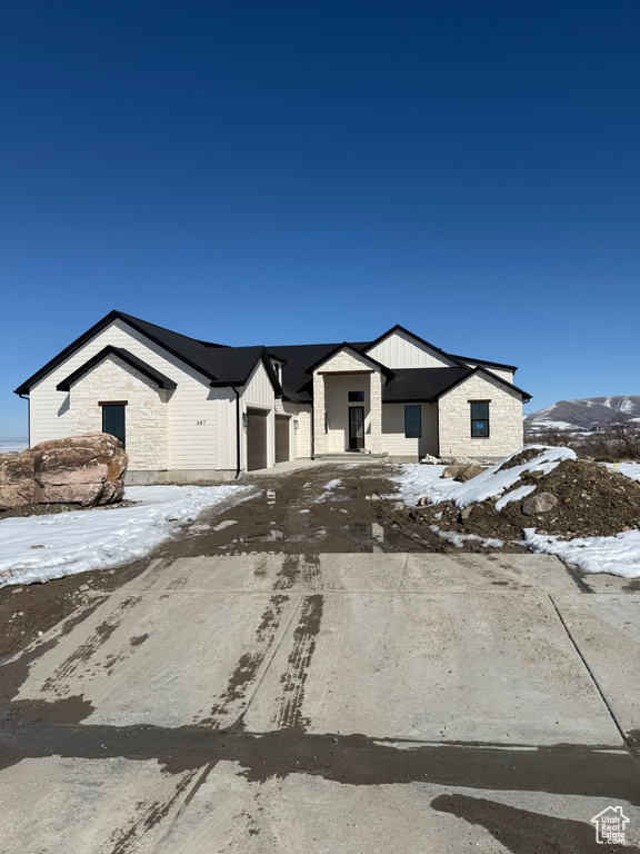 View of front of home with a garage and board and batten siding