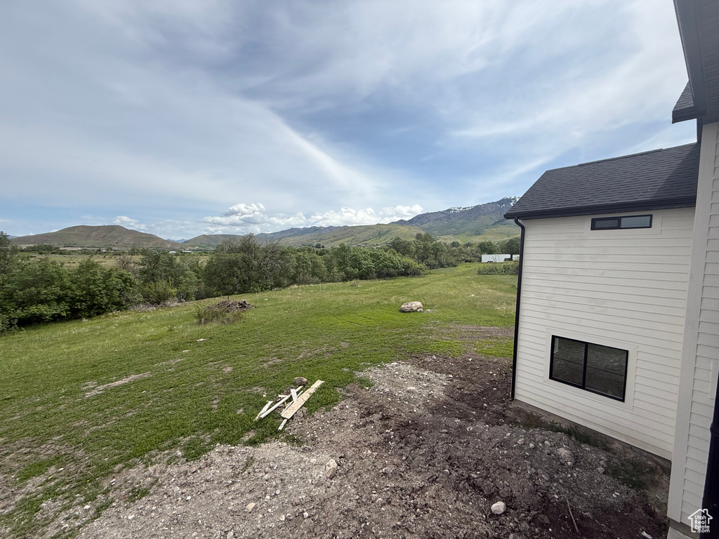 View of grassy yard with a mountain view