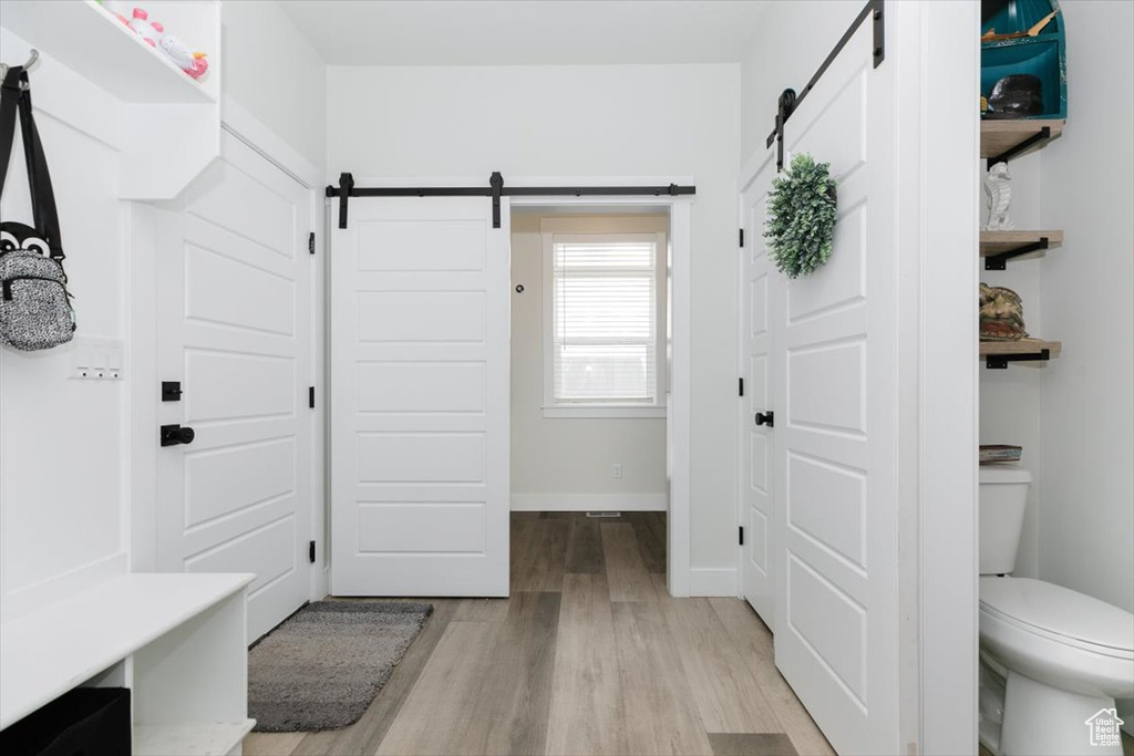 Mudroom featuring a barn door and light hardwood / wood-style floors