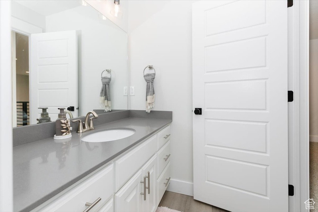 Bathroom with vanity and hardwood / wood-style flooring