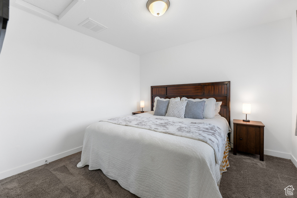 Bedroom with dark colored carpet