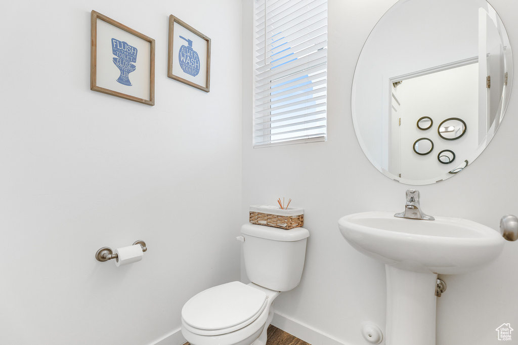 Bathroom with wood-type flooring and toilet