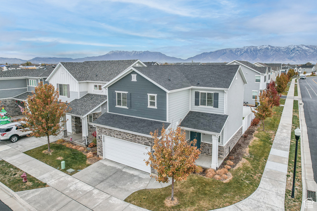 View of front of property featuring a mountain view and a garage