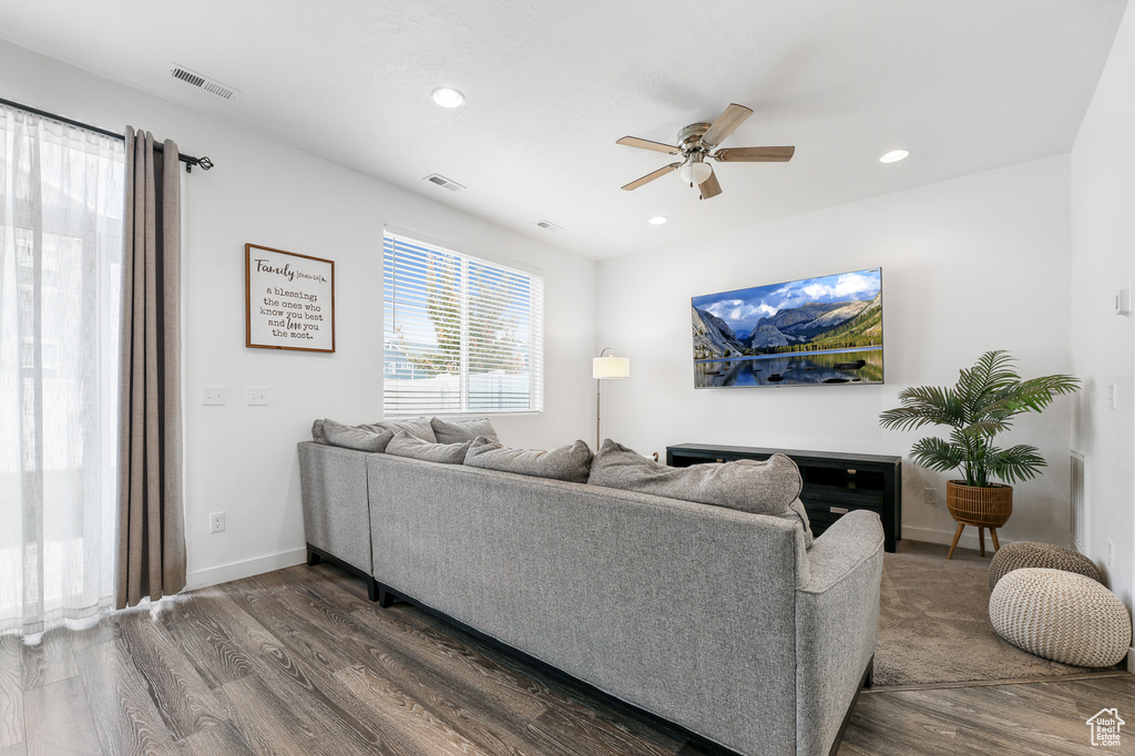 Living room with hardwood / wood-style flooring and ceiling fan