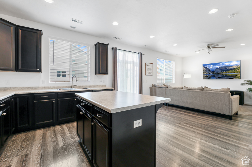 Kitchen featuring a center island, light hardwood / wood-style floors, ceiling fan, and sink