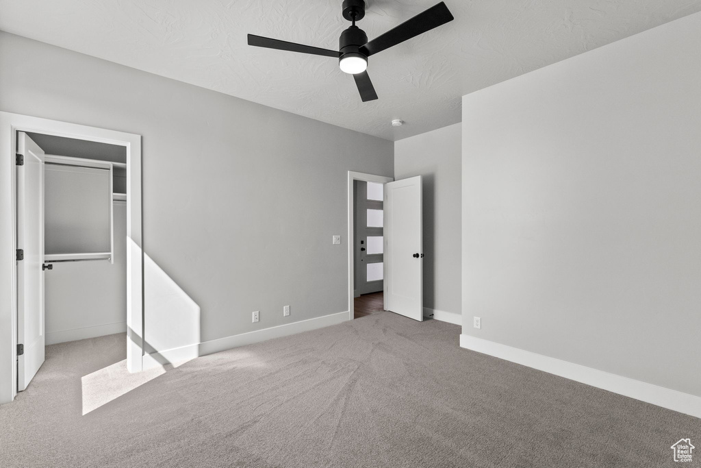 Unfurnished bedroom featuring a closet, ceiling fan, baseboards, and carpet floors