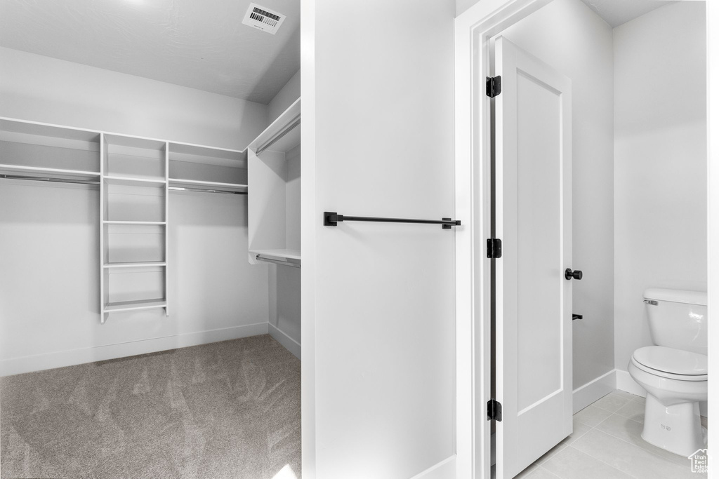 Bathroom with visible vents, baseboards, and toilet