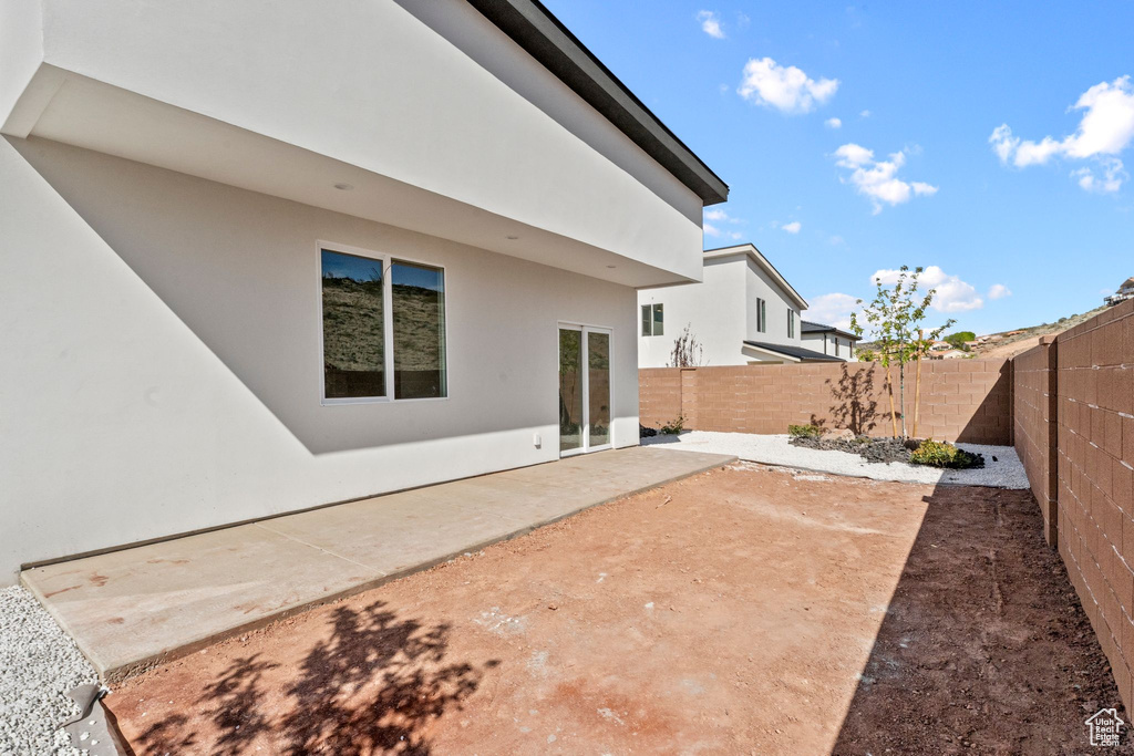 Back of property with a patio area, a fenced backyard, and stucco siding