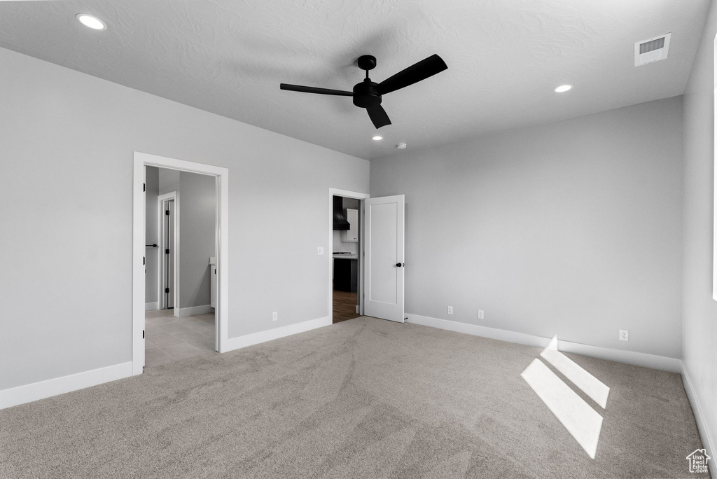 Unfurnished bedroom with recessed lighting, visible vents, light colored carpet, and baseboards