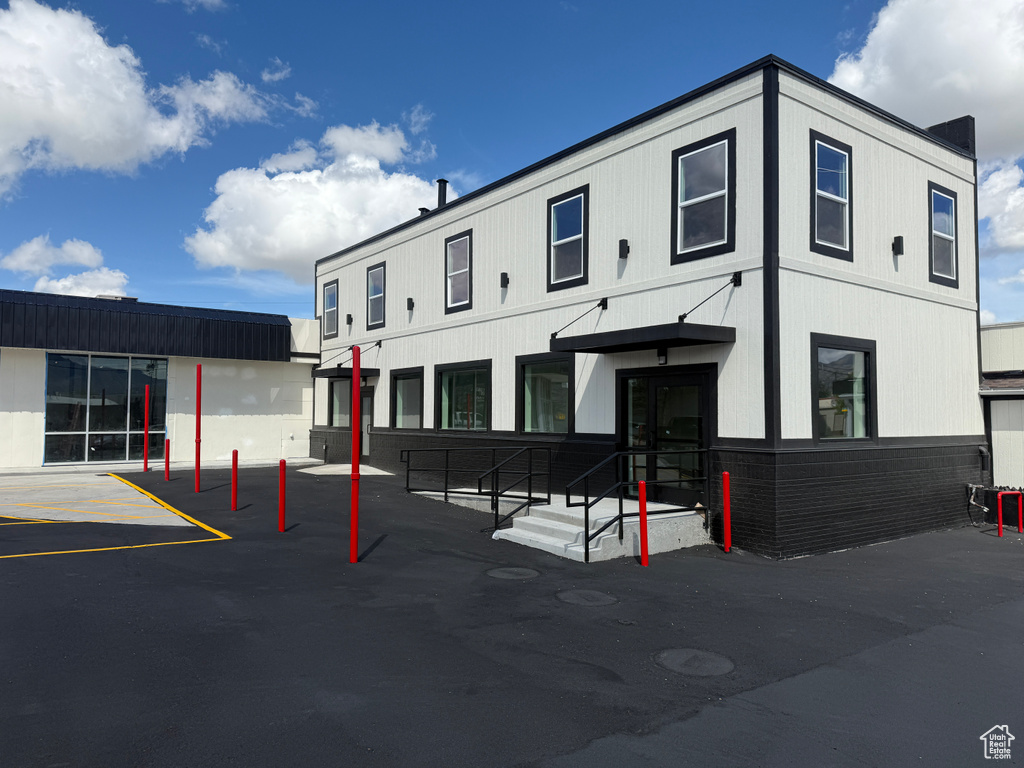 View of building exterior with uncovered parking