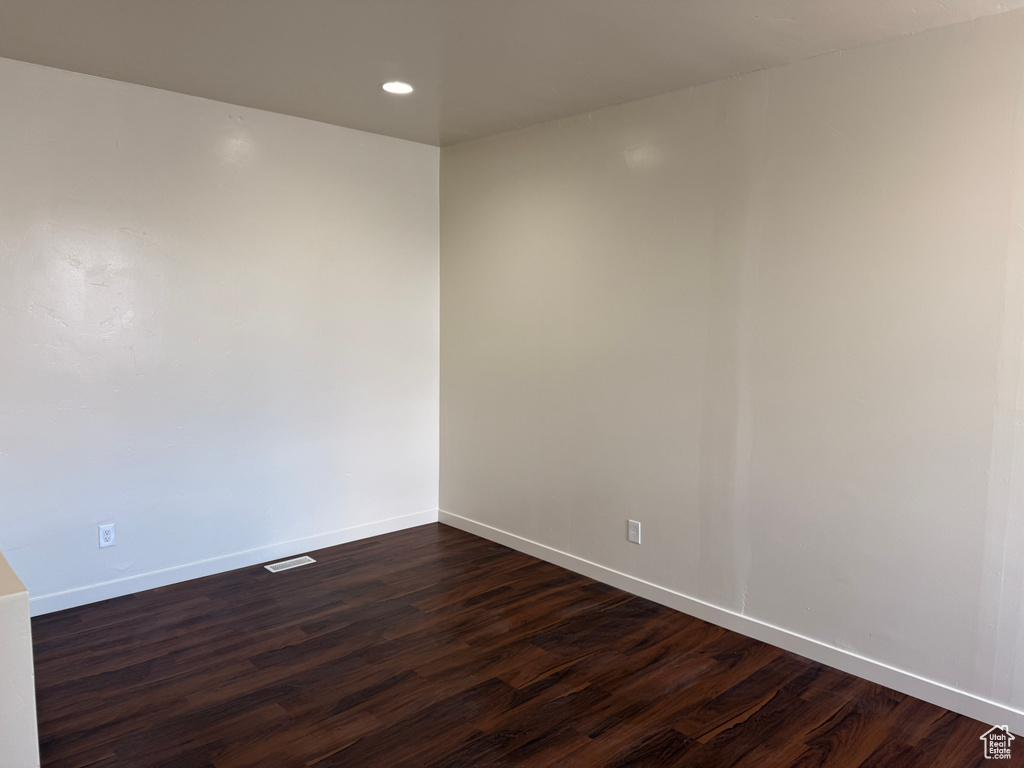 Spare room with recessed lighting, baseboards, dark wood finished floors, and visible vents
