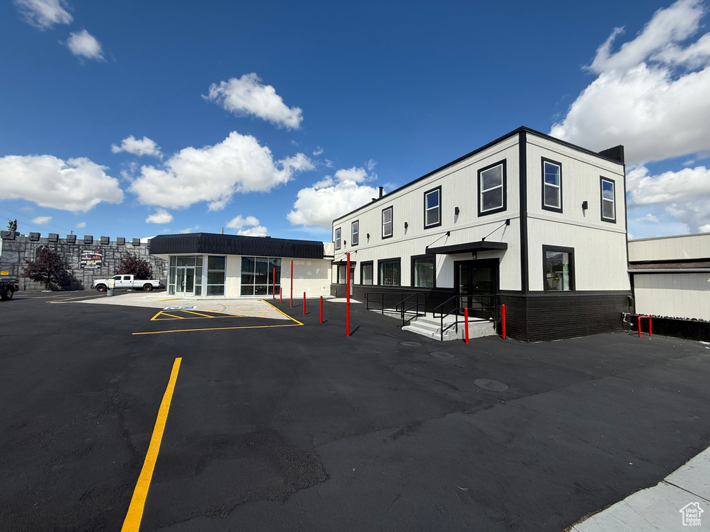 View of building exterior featuring uncovered parking