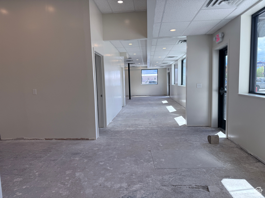 Hallway featuring visible vents, recessed lighting, and a drop ceiling