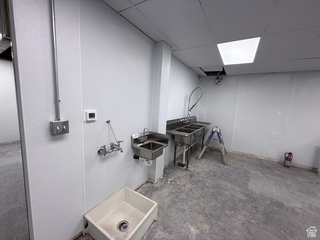 Finished below grade area with a sink and a drop ceiling
