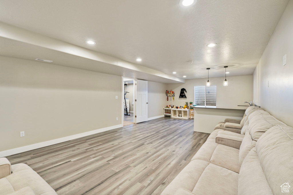 Living room featuring a textured ceiling and light hardwood / wood-style flooring