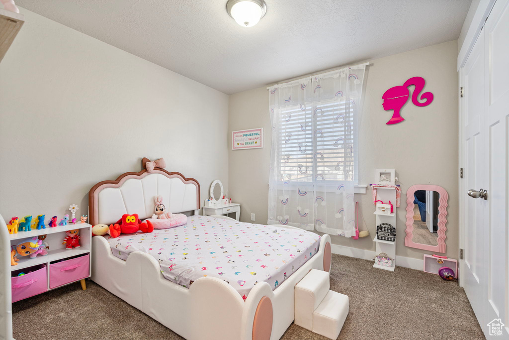 Bedroom featuring dark colored carpet