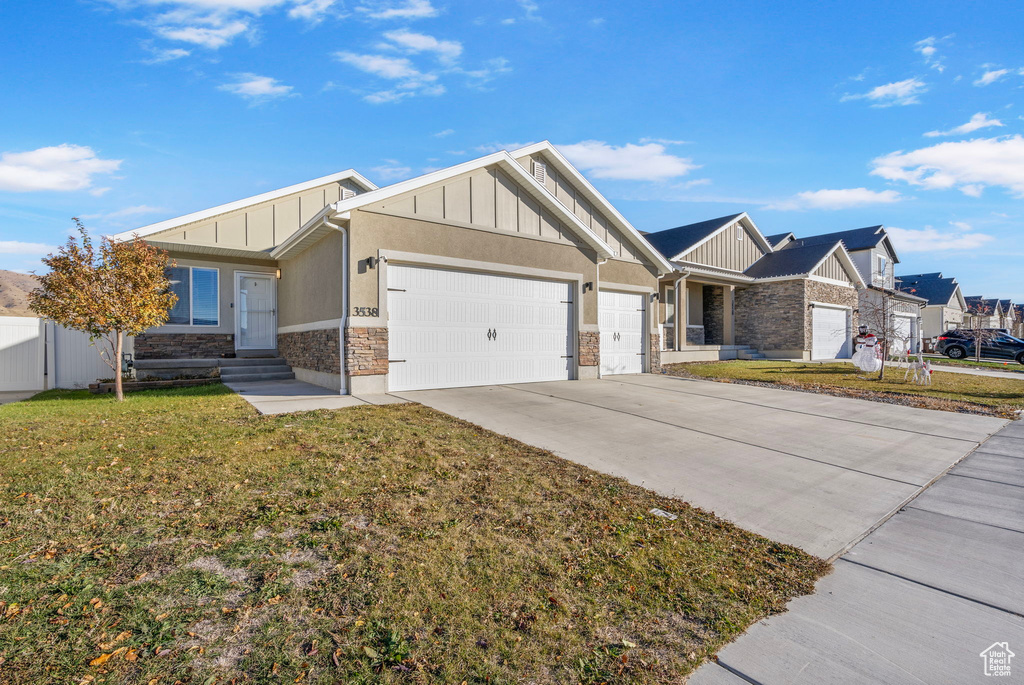 View of front of house with a front yard and a garage