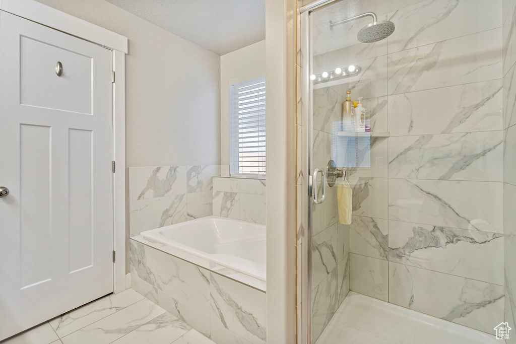 Bathroom featuring independent shower and bath