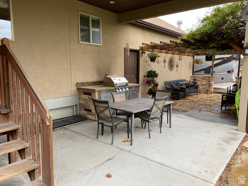 View of patio featuring area for grilling