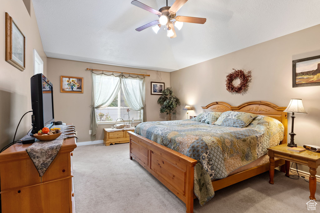 Bedroom featuring ceiling fan and light carpet