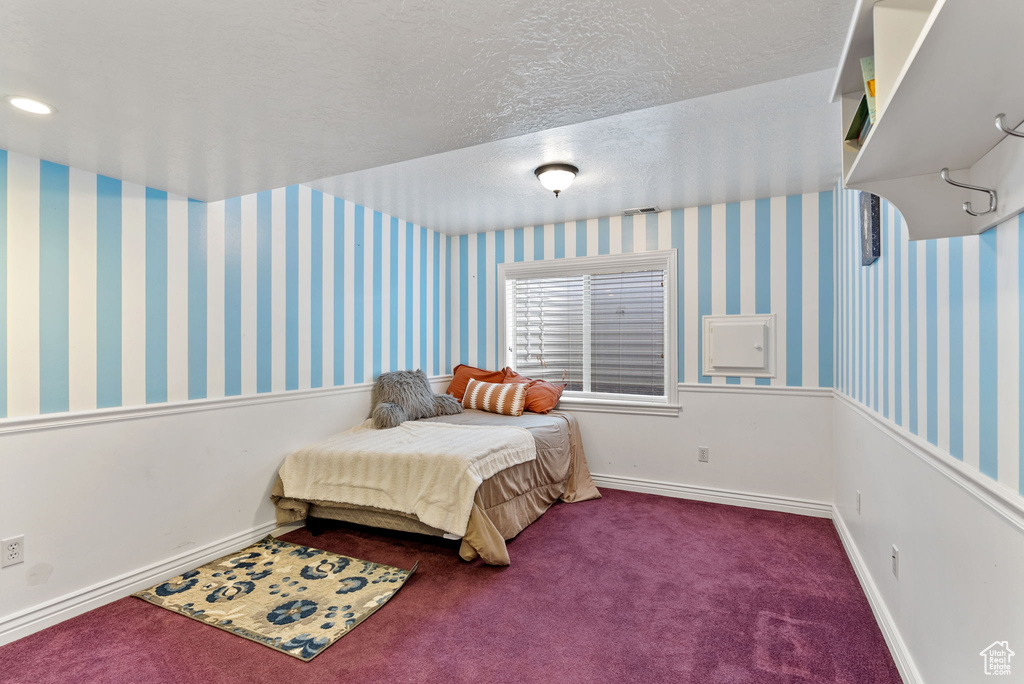 Bedroom with carpet floors and a textured ceiling