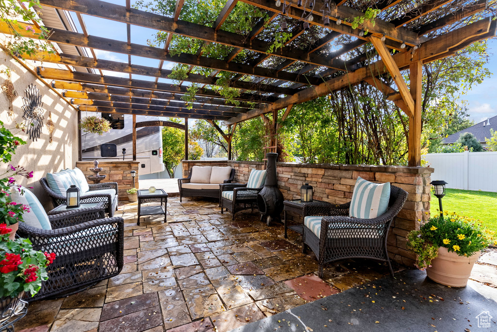 View of patio featuring a pergola and an outdoor hangout area