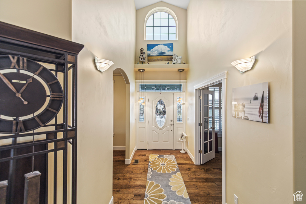 Entrance foyer featuring dark hardwood / wood-style flooring and lofted ceiling