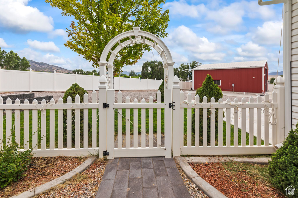 Gate featuring a fenced front yard and a mountain view
