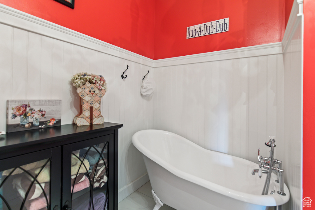 Bathroom featuring a bath and tile patterned floors