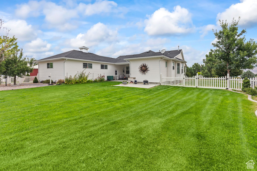 Rear view of house featuring a patio
