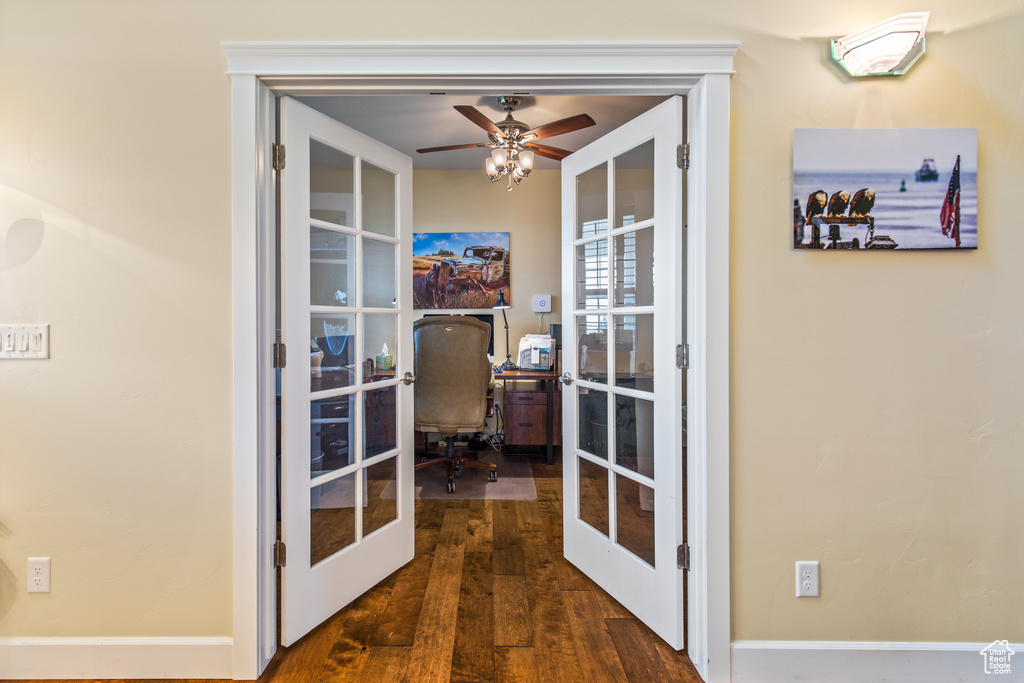Interior space with ceiling fan, dark hardwood / wood-style flooring, and french doors
