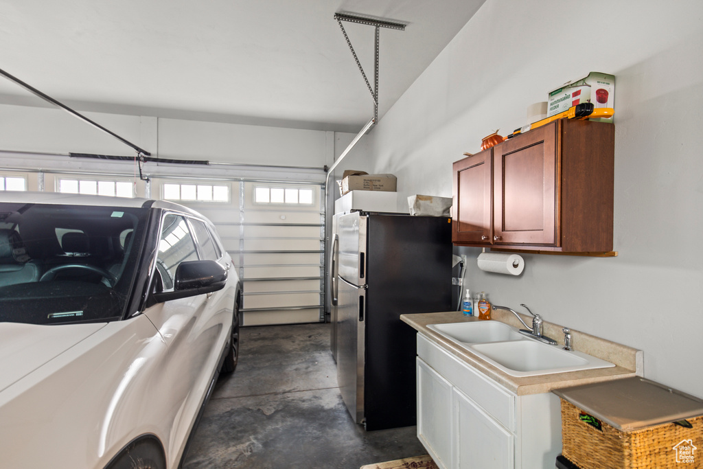Garage featuring stainless steel refrigerator and sink