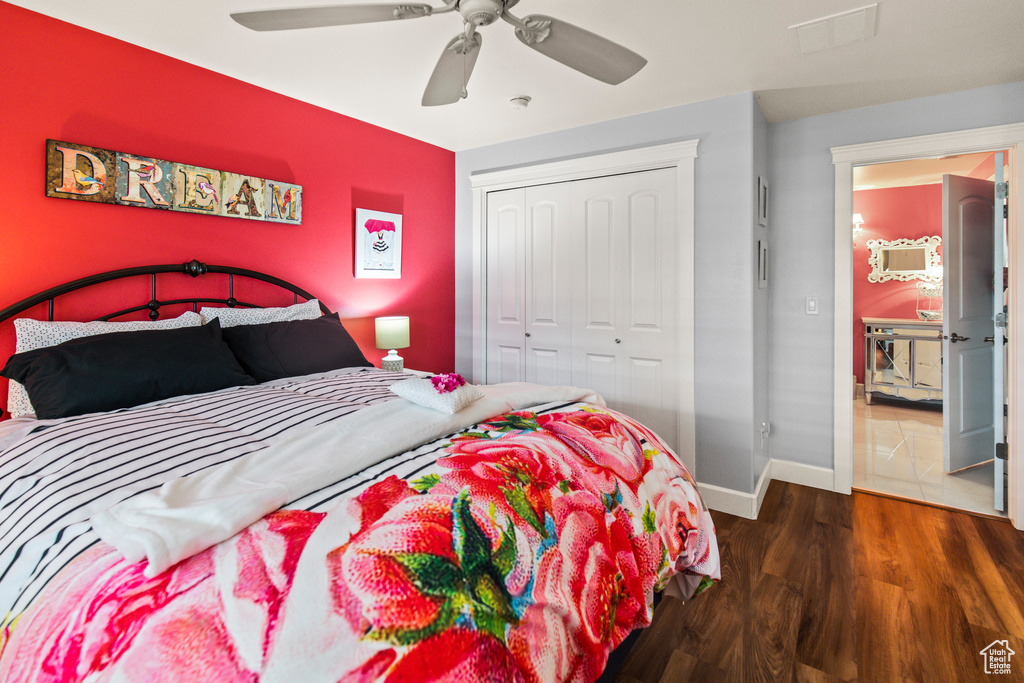 Bedroom featuring ceiling fan, a closet, and dark wood-type flooring