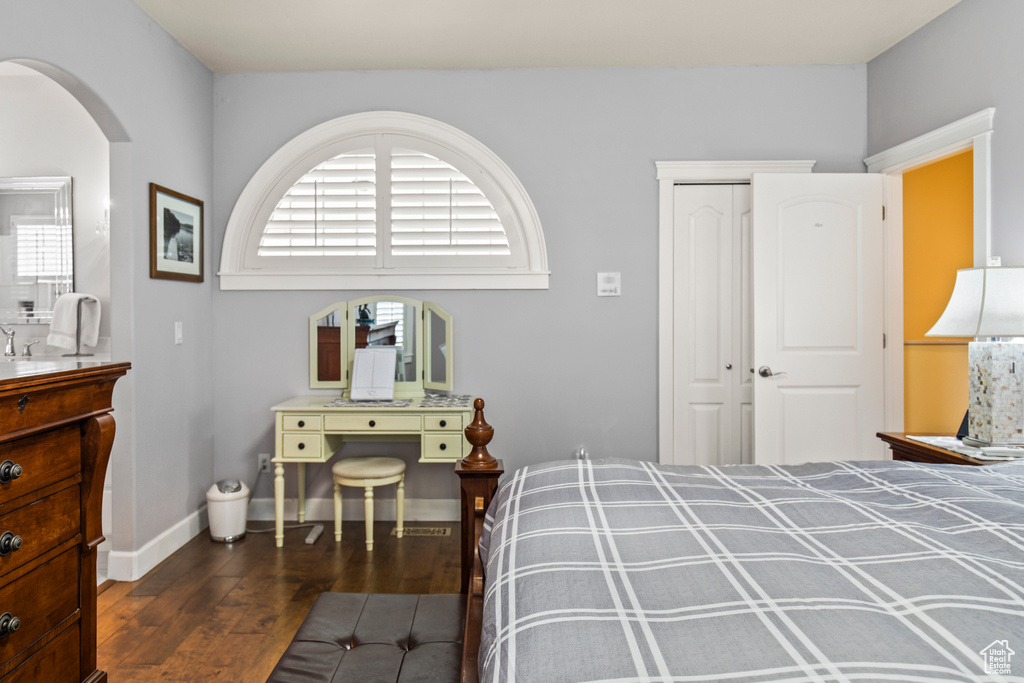 Bedroom featuring dark wood-type flooring and a closet