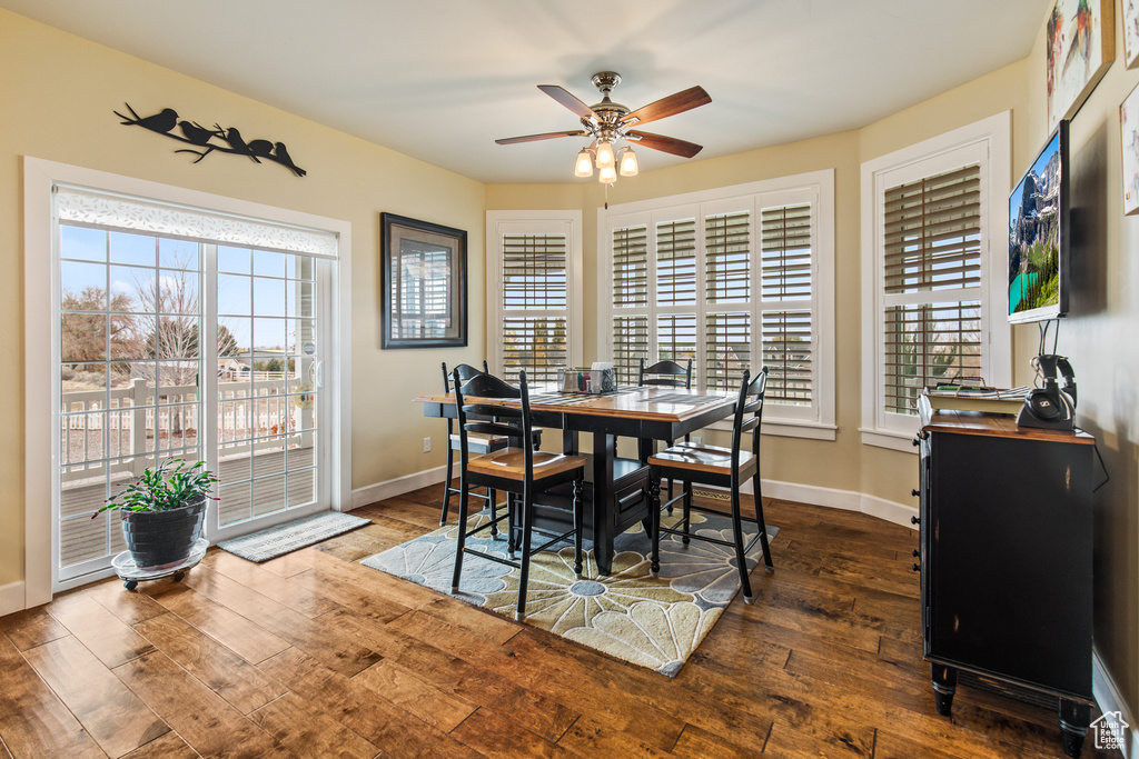 Dining space featuring dark hardwood / wood-style floors and ceiling fan