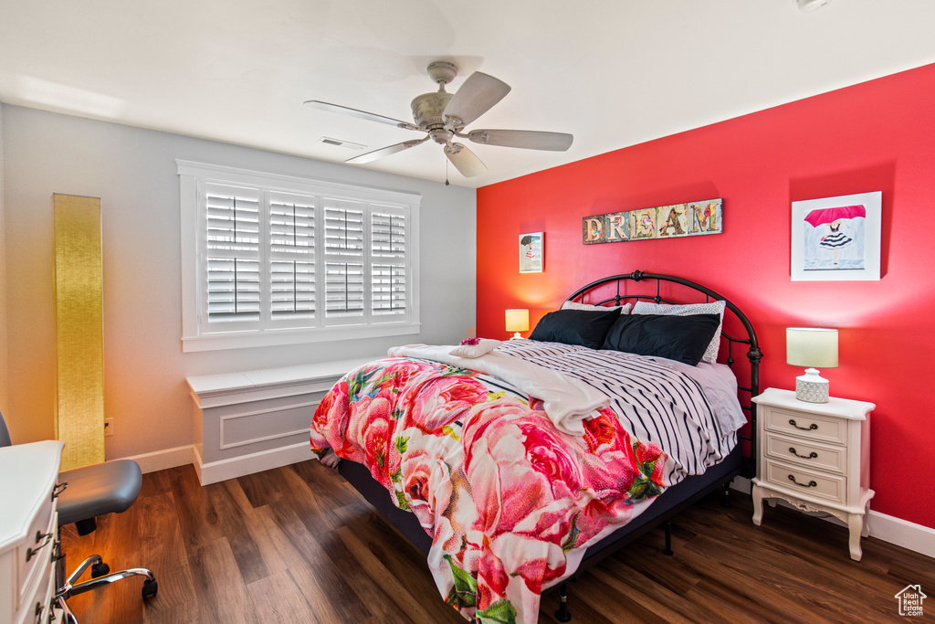 Bedroom featuring ceiling fan and dark hardwood / wood-style flooring