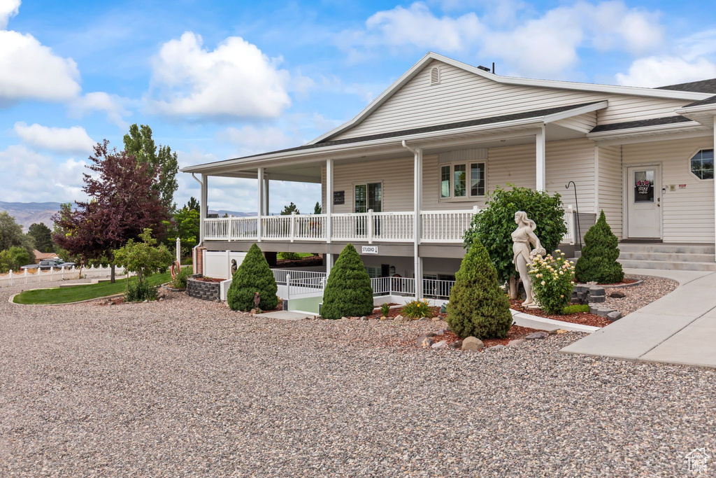 Country-style home featuring covered porch