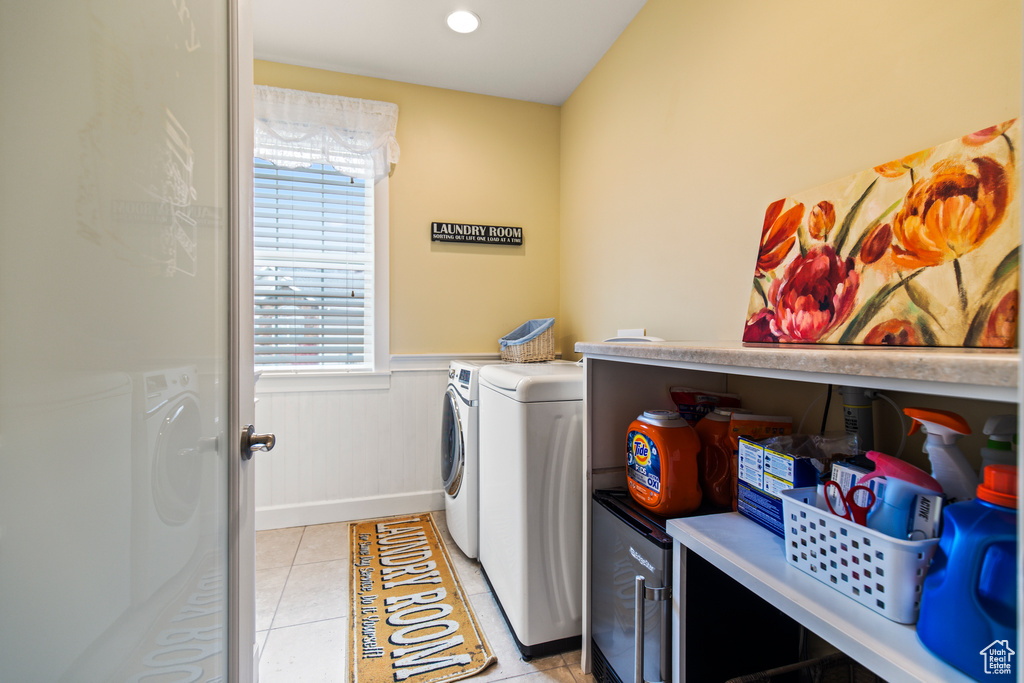 Washroom featuring washing machine and dryer and light tile patterned floors