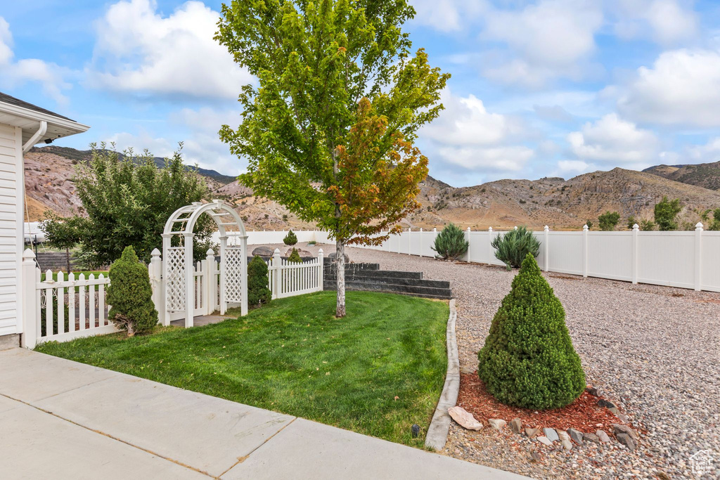 Fenced backyard featuring a mountain view