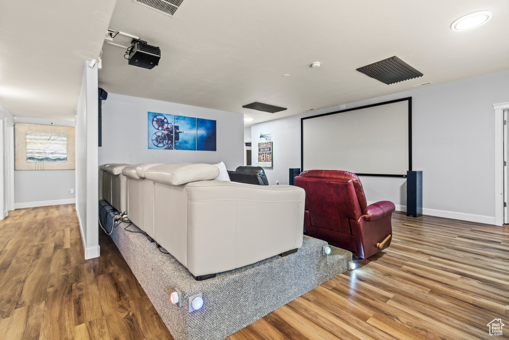 Cinema featuring hardwood / wood-style floors