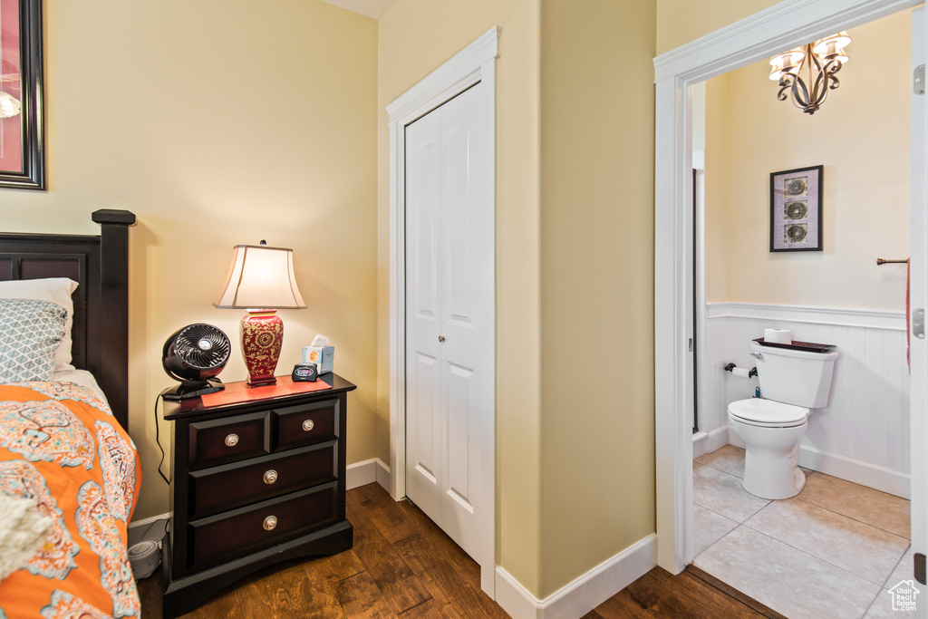 Bedroom featuring a closet and dark hardwood / wood-style flooring