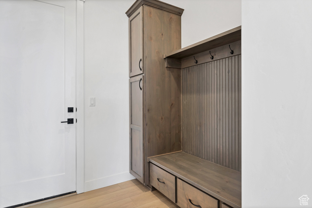 Mudroom with light wood-type flooring and baseboards