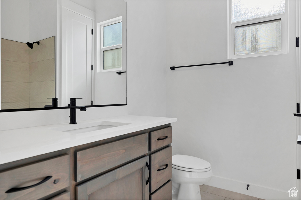 Full bathroom with vanity, tile patterned floors, and a shower