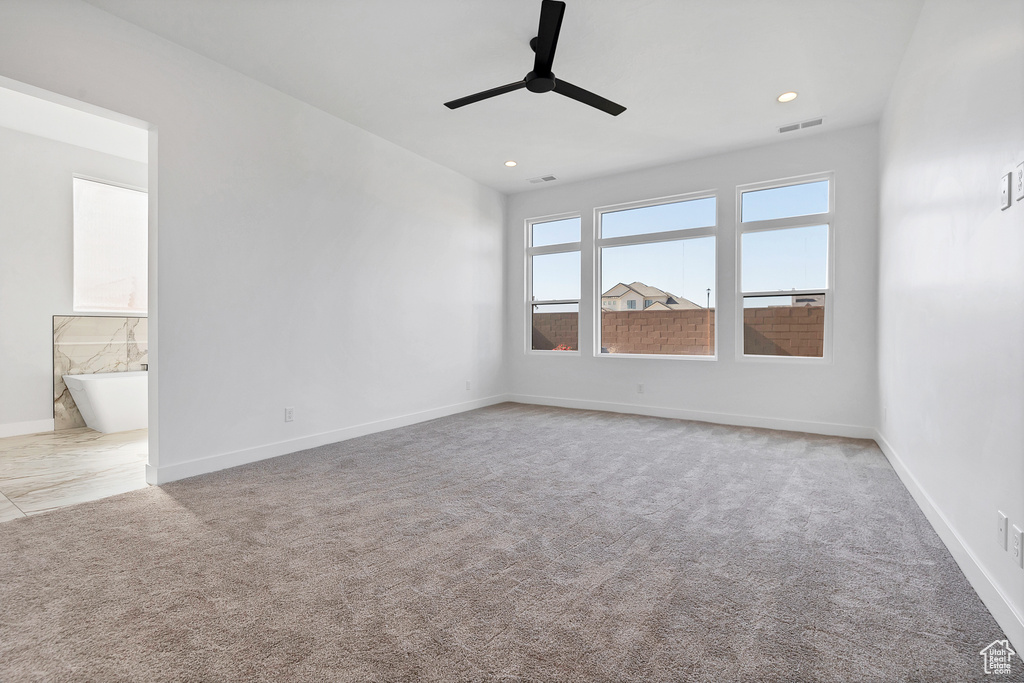 Unfurnished room with ceiling fan, light carpet, and recessed lighting