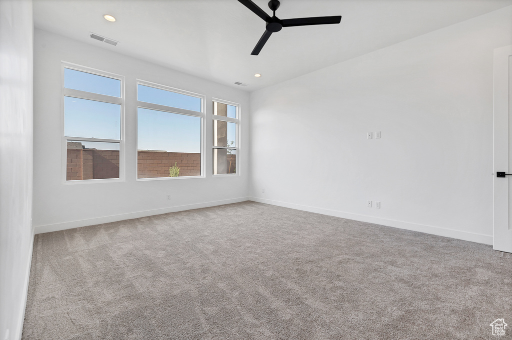 Spare room featuring a ceiling fan, carpet floors, and recessed lighting